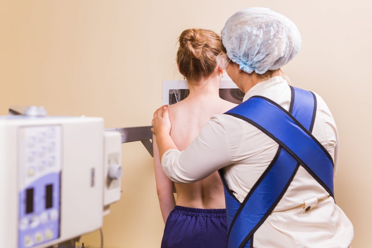 female-nurse-preparing-patient-for-chest-x-ray-in-HU8UARW-min-1200x800.jpg